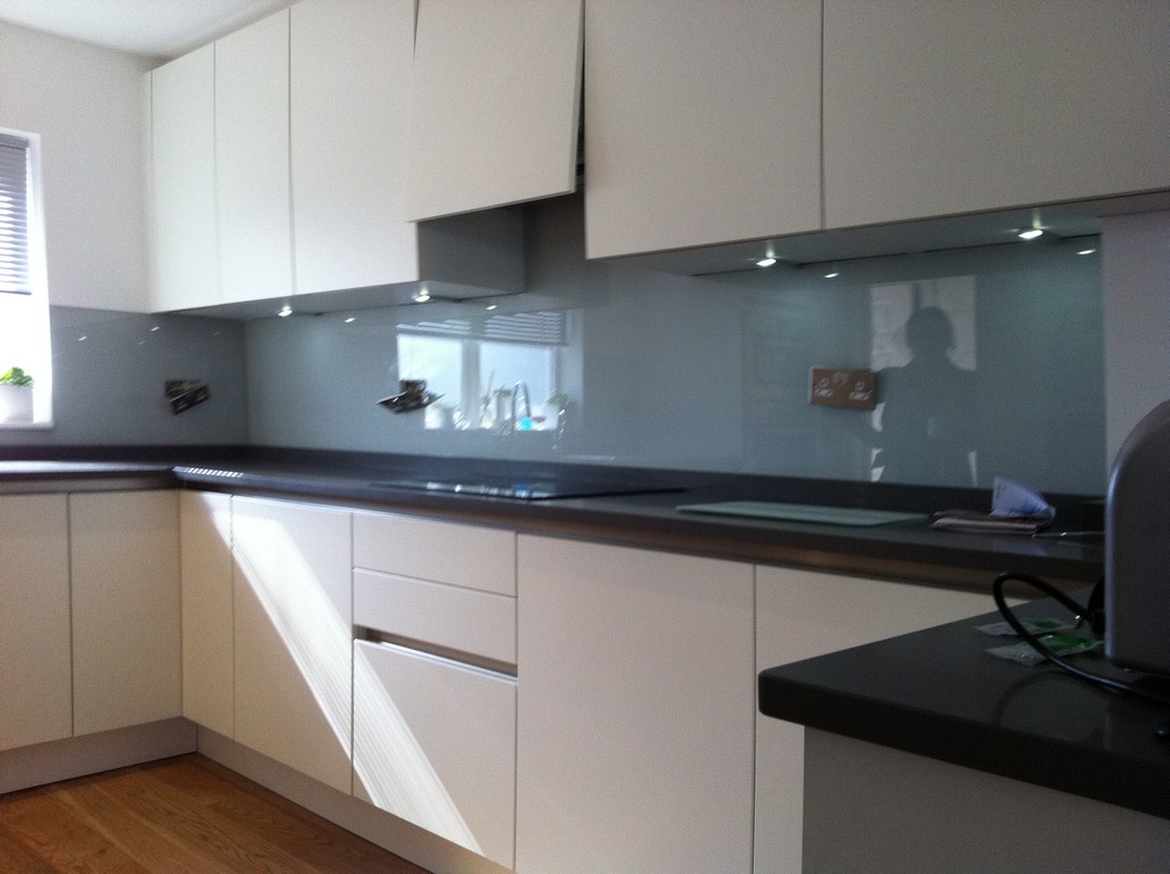 Grey glass kitchen splashback with LED lighting in West Brompton