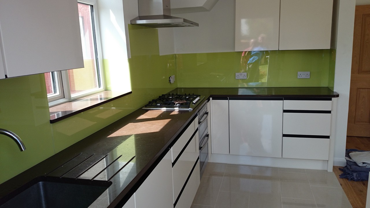 Lime green glass kitchen splashback installed by West Brompton glaziers