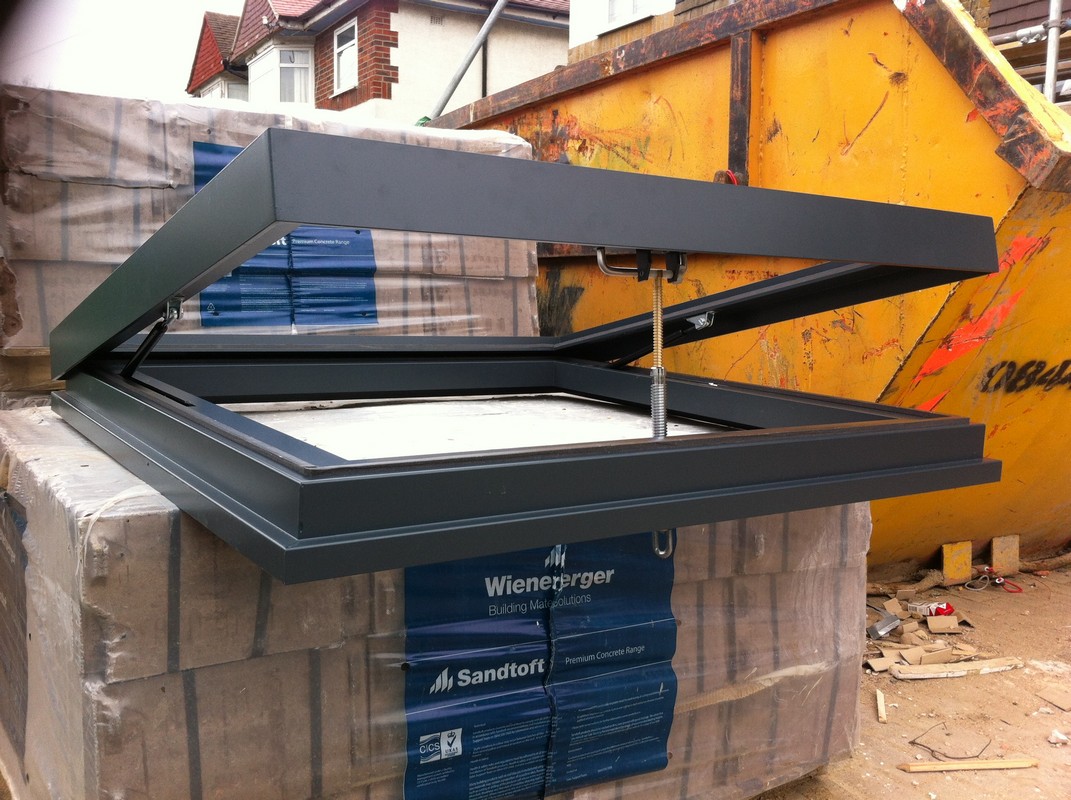 Opening flat roof skylight in anthracite grey installed in West Brompton