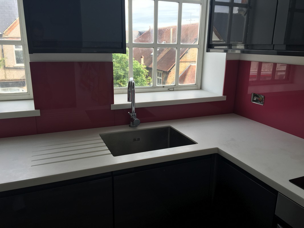 Deep plum coloured glass splashback in modern West Brompton kitchen