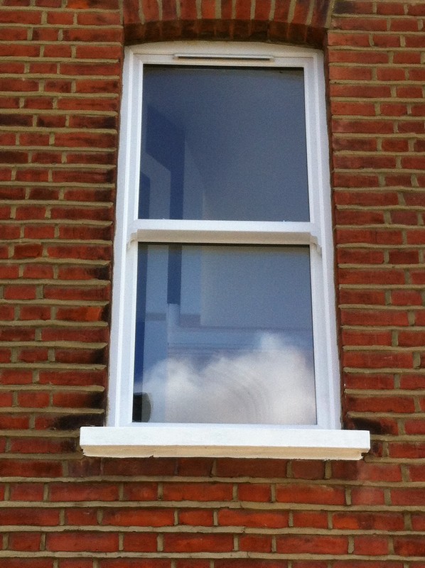 uPVC sash window on Victorian red brick house in West Brompton